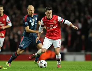 Images Dated 19th February 2014: Mesut Ozil (Arsenal) Arjen Robben (Bayern). Arsenal 0: 2 Bayern Munich. UEFA Champions League