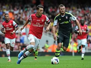 Images Dated 22nd September 2013: Mesut Ozil (Arsenal) Erik Pieters (Stoke). Arsenal 3: 1 Stoke City. Barclays Premier League