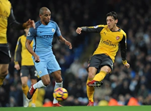 Images Dated 18th December 2016: Mesut Ozil (Arsenal) Fernando (Man City). Manchester City 2: 1 Arsenal. Premier League