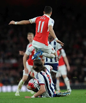 Images Dated 21st April 2016: Mesut Ozil (Arsenal) Jonas Olsson (WBA). Arsenal 2: 0 West Bromwich Albion