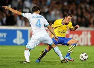 Images Dated 18th September 2013: Mesut Ozil (Arsenal) Lucas Mendes (Marseille). Olympic Marseille 1: 2 Arsenal. UEFA Champions League