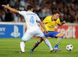 Marseille v Arsenal 2013-14 Gallery: Mesut Ozil (Arsenal) Lucas Mendes (Marseille). Olympic Marseille 1: 2 Arsenal. UEFA Champions League