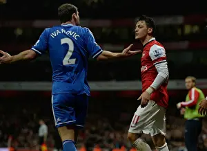 Arsenal V Chelsea 2013-14 Prints: Mesut Ozil and Branislav Ivanovic: A Battle of Midfield Masters at the Emirates Stadium (Arsenal v Chelsea 2013-14)