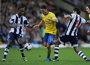 West Bromwich Albion V Arsenal 2013-14 Prints: Mesut Ozil Clashes with Claudio Yacob and Saido Berahino during West Bromwich Albion vs Arsenal