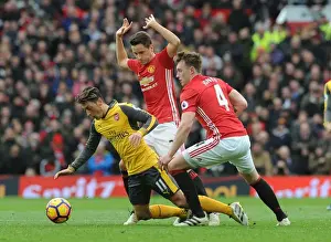 Manchester United V Arsenal 2016-17 Prints: Mesut Ozil Clashes with Manchester United's Ander Herrera