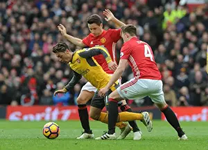 Manchester United V Arsenal 2016-17 Prints: Mesut Ozil Clashes with Manchester United's Herrera and Jones during the 2016-17 Premier League Match