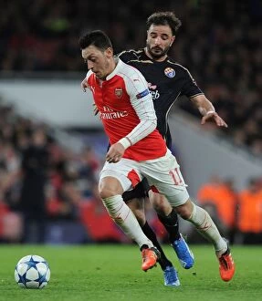 Images Dated 24th November 2015: Mesut Ozil Escapes Past Goncalo Santos: Arsenal's Thrilling Chase in the UEFA Champions League vs