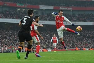 Images Dated 11th February 2017: Mesut Ozil Faces Off Against Harry Maguire: Arsenal vs Hull City, Premier League 2016-17
