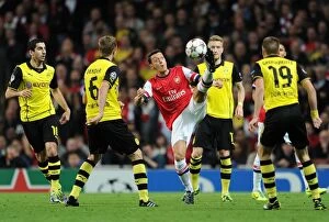 Arsenal v Borussia Dortmund 2013-14 Collection: Mesut Ozil Faces Off Against Sven Bender and Henrikh Mkhitaryan: Arsenal vs Borussia Dortmund