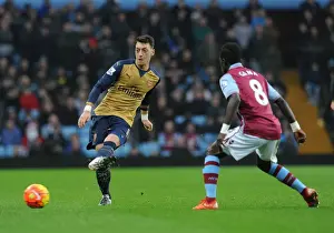 Aston Villa V Arsenal 2015-16 Prints: Mesut Ozil Faces Pressure from Idrissa Gana: A Battle in the Premier League (Aston Villa vs Arsenal)