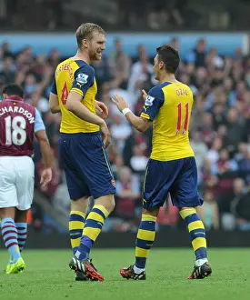 Aston Villa V Arsenal 2014-15 Prints: Mesut Ozil and Per Mertesacker Celebrate Arsenal's First Goal Against Aston Villa (2014-15)