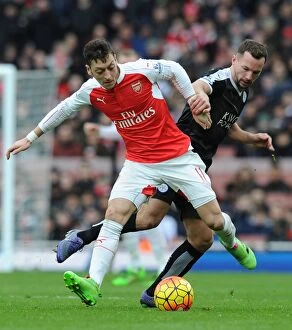 Images Dated 14th February 2016: Mesut Ozil Outmaneuvers Christian Fuchs in Arsenal's Premier League Battle Against Leicester City