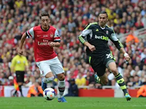 Arsenal V Stoke City 2013-14 Prints: Mesut Ozil Outmaneuvers Geoff Cameron in Arsenal's Victory over Stoke City