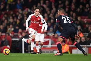 Images Dated 29th November 2017: Mesut Ozil Outmaneuvers Mathias Jogensen: Arsenal vs. Huddersfield Town, Premier League 2017-18