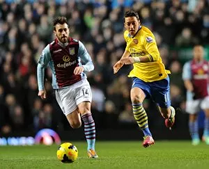 Images Dated 13th January 2014: Mesut Ozil Outruns Antonio Luna: Aston Villa vs. Arsenal, Premier League 2013-14