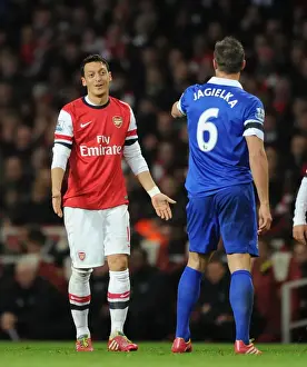 Arsenal V Everton 2013-14 Prints: Mesut Ozil and Phil Jagielka: A Moment of Respite Amidst the Arsenal v Everton Rivalry (2013-14)