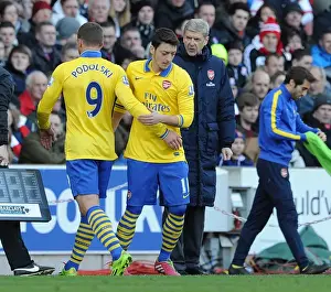 Stoke City V Arsenal 2013-14 Prints: Mesut Ozil Replaces Lukas Podolski: Arsene Wenger Makes Substitution during Arsenal's Match against Stoke City