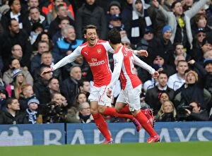 Tottenham Hotspur v Arsenal 2014-15 Collection: Mesut Ozil and Santi Cazorla Celebrate Goals: Arsenal's Victory at Tottenham Hotspur (2014-15)