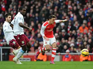 Mesut Ozil scores Arsenals 2nd goal under pressure from Jores Okore and Carles Gil (Villa)