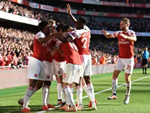 Arsenal V Watford 2018-19 Prints: Mesut Ozil Scores and Celebrates with Arsenal Team Mates: Arsenal vs