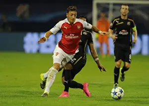 Mesut Ozil Scores Past Dinamo Zagreb's Defense in 2015-16 UEFA Champions League: Arsenal's Star Playmaker in Action