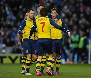 Images Dated 25th January 2015: Mesut Ozil and Teammates Celebrate Goal Against Brighton & Hove Albion in FA Cup Fourth Round