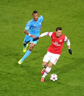 Arsenal V Marseille 2013-14 Prints: Mesut Ozil vs. Alaixys Romao: A Football Rivalry Ignites in the Arsenal vs