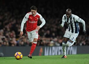 Images Dated 26th December 2016: Mesut Ozil vs Allan Nyom: Battle in the Midfield - Arsenal vs West Bromwich Albion (2016-17)