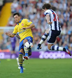 West Bromwich Albion V Arsenal 2013-14 Prints: Mesut Ozil vs Billy Jones: Clash at The Hawthorns - Arsenal vs West Bromwich Albion