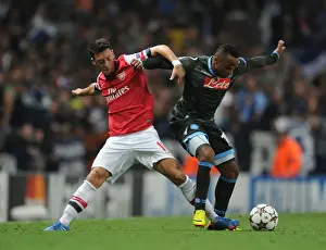 Arsenal V Napoli 2013-14 Prints: Mesut Ozil vs. Camilo Zuniga: Clash at the Emirates - Arsenal v Napoli