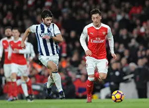 Arsenal V West Bromwich Albion 2016-17 Prints: Mesut Ozil vs. Claudio Yacob: Battle in the Midfield - Arsenal v West Bromwich Albion