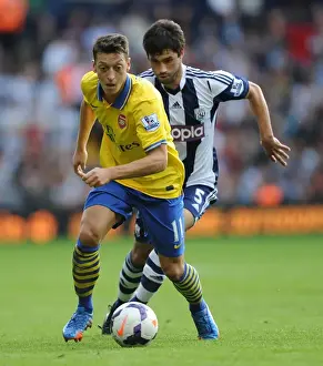 West Bromwich Albion V Arsenal 2013-14 Prints: Mesut Ozil vs. Claudio Yacob: A Battle in the Premier League