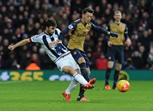 Images Dated 21st November 2015: Mesut Ozil vs Claudio Yacob: A Midfield Battle - West Bromwich Albion vs Arsenal (2015-16)