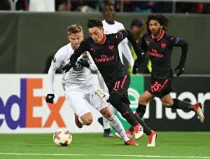 Ostersunds V Arsenal 2017-18 Prints: Mesut Ozil vs. Dennis Widgren: Clash in the Europa League between Ostersunds and Arsenal