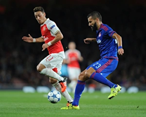 Arsenal V Olympiacos 2015/16 Prints: Mesut Ozil vs. Dimitris Siovas: Arsenal vs
