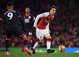 Images Dated 29th November 2017: Mesut Ozil vs Elias Kachunga: Battle at the Emirates - Arsenal v Huddersfield Town