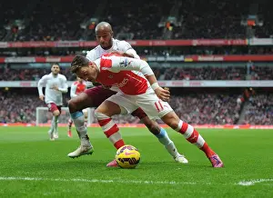 Arsenal V Aston Villa 2014-15 Prints: Mesut Ozil vs Fabian Delph: Intense Battle at Arsenal's Emirates Stadium (Arsenal v Aston Villa)