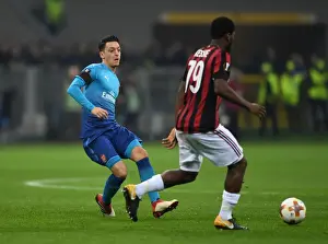 AC Milan V Arsenal 2017-18 Prints: Mesut Ozil vs. Franck Kessie: Battle in the Midfield - Arsenal vs