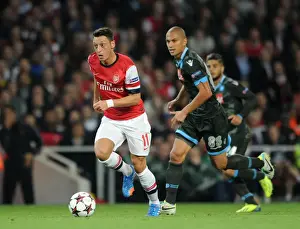 Arsenal V Napoli 2013-14 Prints: Mesut Ozil vs. Gokhan Inler: Battle in the Arsenal v Napoli UEFA Champions League Match