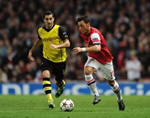 Arsenal v Borussia Dortmund 2013-14 Collection: Mesut Ozil vs. Henrikh Mkhitaryan: Clash of the Playmakers - Arsenal v Borussia Dortmund