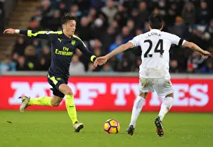 Swansea City V Arsenal - 2016-17 Prints: Mesut Ozil vs Jack Cork: Intense Battle in Swansea City vs Arsenal Premier League Clash