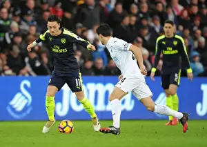 Swansea City V Arsenal - 2016-17 Prints: Mesut Ozil vs Jack Cork: A Premier League Showdown at Swansea City