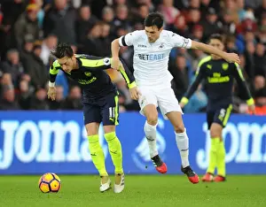 Swansea City V Arsenal - 2016-17 Prints: Mesut Ozil vs Jack Cork: A Premier League Showdown at Swansea City