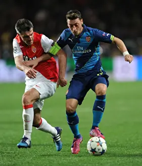 Monaco V Arsenal 2014/15 Prints: Mesut Ozil vs. Jeremy Toulalan: Intense Clash in Monaco's UCL Showdown against Arsenal