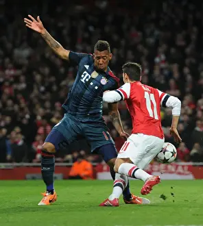 Arsenal V Bayern Munich 2013-14 Prints: Mesut Ozil vs Jerome Boateng: Penalty Showdown in Arsenal vs Bayern Munich UCL Clash