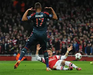Arsenal V Bayern Munich 2013-14 Prints: Mesut Ozil vs Jerome Boateng: A Penalty Showdown in the Arsenal vs Bayern Munich UCL Clash