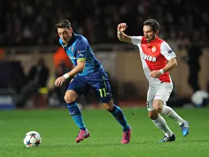 Monaco V Arsenal 2014/15 Prints: Mesut Ozil vs Joao Moutinho: A Battle of Midfield Maestros in Monaco v Arsenal