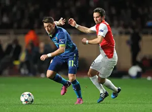 Monaco V Arsenal 2014/15 Prints: Mesut Ozil vs Joao Moutinho: Battle in the UEFA Champions League Round of 16 between Monaco and Arsenal