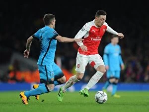 Arsenal v Barcelona 2015/16 Collection: Mesut Ozil vs. Jordi Alba: A Champions League Showdown at the Emirates