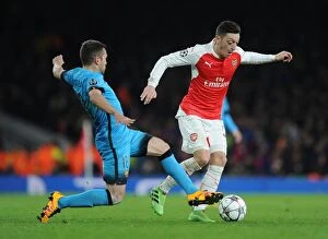 Arsenal v Barcelona 2015/16 Collection: Mesut Ozil vs. Jordi Alba: A Champions League Battle at the Emirates